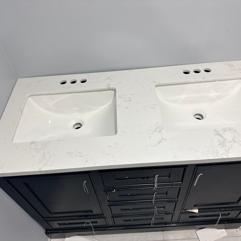 A new double sink bathroom vanity with a white stone top