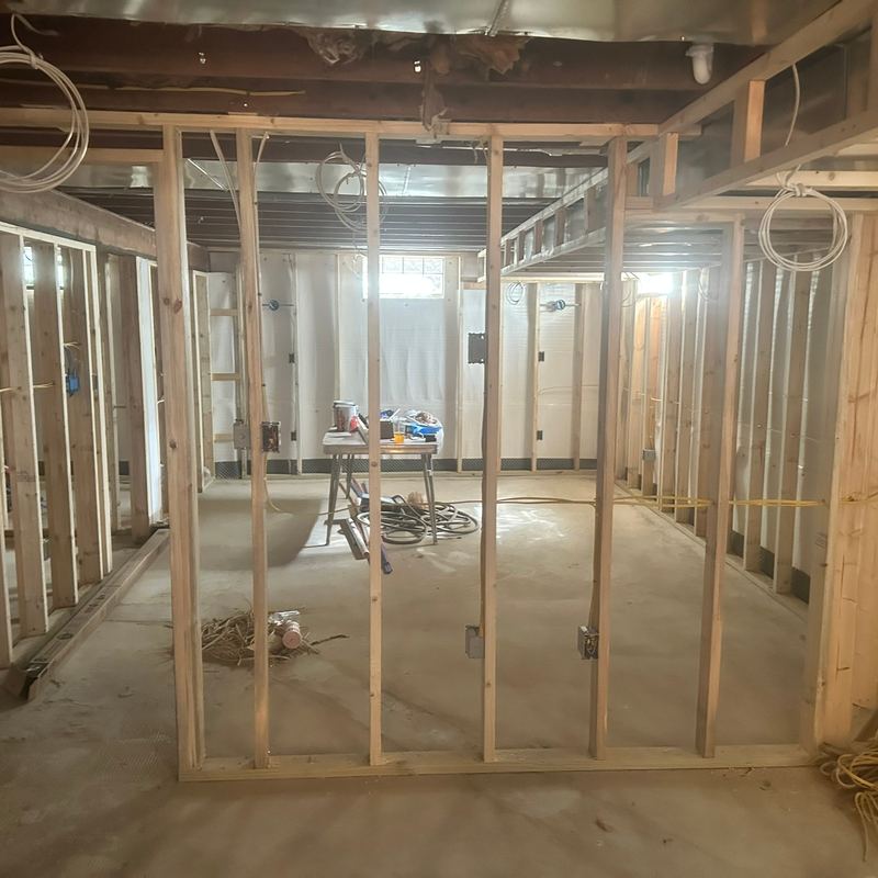New wood stud walls framed across a basement